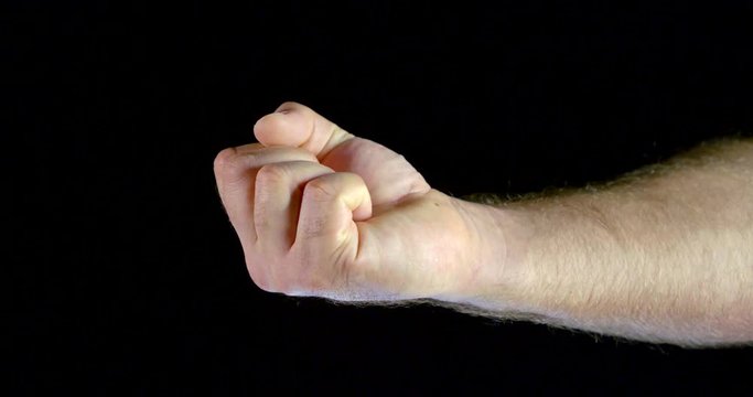 man is clenching his hand into a fist and opening palm, closeup view