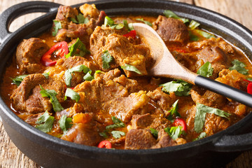 Indian traditional food Lamb rogan josh close-up in a pan. horizontal