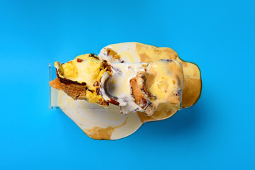 top view three pcs melted ice cream cones on blue background