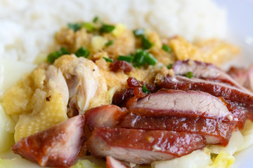 side view fast food of BBQ pork and steamed chicken with cabbage and rice