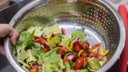 Isolated close up of an organic vegetable salad in the making