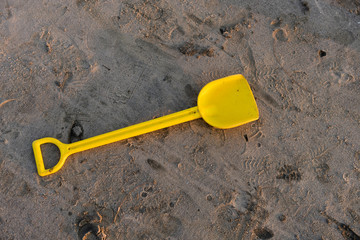 Fototapeta na wymiar toy shovel on sand in day time