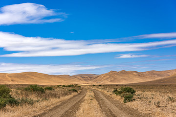 Fototapeta na wymiar Dirt road in the highlands
