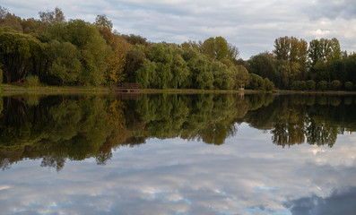 Fototapeta na wymiar Autumn, Park, pond, trees, clouds.