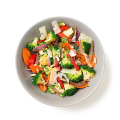 Healthy warm broccoli salad with parmesan cheese and pine nuts. isolated on white background.