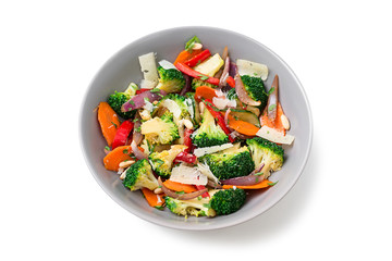 Healthy warm broccoli salad with parmesan cheese and pine nuts. isolated on white background.