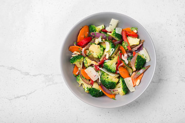 Healthy warm broccoli salad with parmesan cheese and pine nuts.