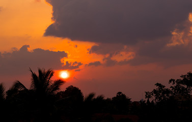 Fiery sunset landscape with darkness foreground in siem reap city in Cambodia during rainy season 