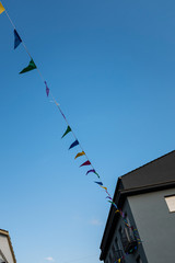 Colourful party flags on an outdoor scene under a blue sky