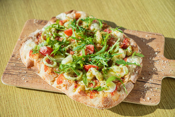 fresh pizza with calamari and arugula