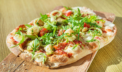 fresh pizza with calamari and arugula