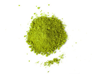 Powdered matcha green tea scattered on white background top view copy space