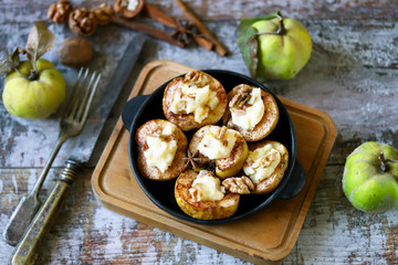 Baked quince with cinnamon and sweet cheese. Healthy autumn dessert. Keto dessert.