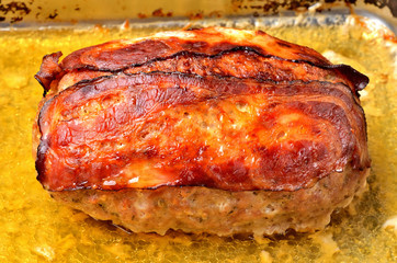 Tasty baked pork meatloaf in pan. Close-up.