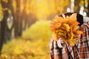 Beautiful Autumn Woman with Autumn Leaves on Fall Nature.