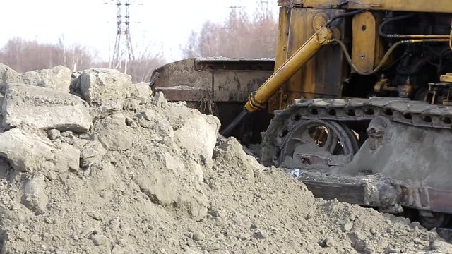 Tractor works on the construction site in the cold winter