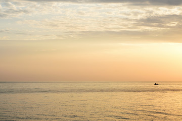 Sea and cloudy sky in the early morning near the coast of Sicily. Cefalu, Italy