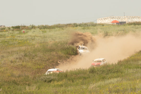 Traditional rally .The racing car drives into a steep turn, scattering, spraying dirt, dust. Extreme rally, autocross