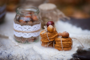 Hazelnuts in the peel and ginger cookies on brown table.   Close up picture