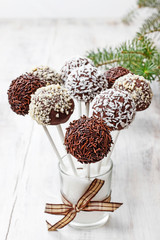 Chocolate cake pops decorated with nuts and shredded desiccated coconut.