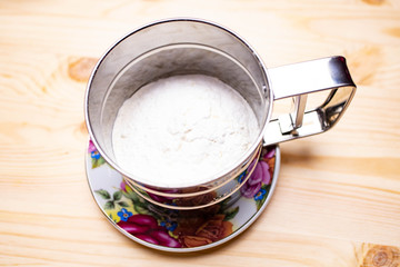 stainless steel flour mug with blades on the table. Mug with flour