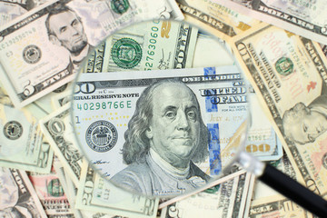 American dollars banknotes background under magnifying glass. Money background