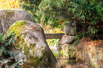 A water stream flowing among stone boulders