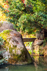A water stream flowing among stone boulders
