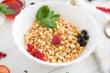 healthy breakfast with muesli and berry Healthy tasty breakfast of muesli with strawberries, raspberries, black currants and red currants.