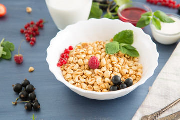 healthy breakfast with muesli and berry Healthy tasty breakfast of muesli with strawberries, raspberries, black currants and red currants.