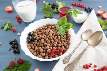 breakfast Healthy tasty breakfast chocolate balls with strawberries, raspberries, black currants and red currants.