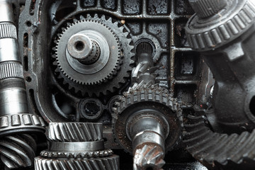 Dismantled car gearbox with gears, close-up. Repair box predach, repair of used cars. Metal background.