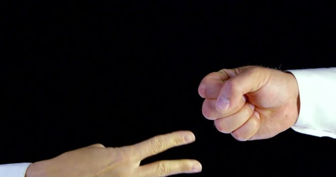 two people are playing rock-paper-scissors in black background, rock is winning