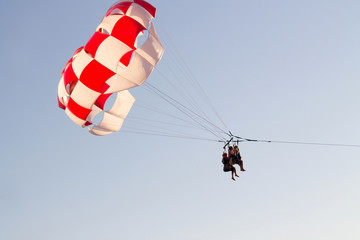 paragliding in the sky over the blue sea