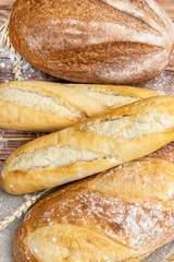 Different loafs of fresh bread on wooden table. top view. Food background.