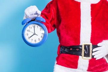 Santa Claus with the alarm clock in his hand