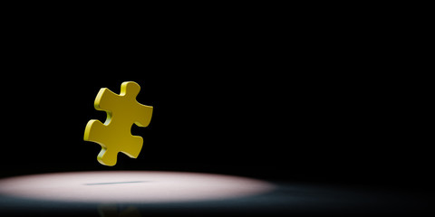 Obraz premium Puzzle Piece Spotlighted on Black Background