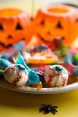 Fototapeta na wymiar halloween candies with orange pumpkin in the background