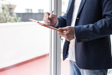 businessman signing documents in the office, real estate and mortgage concept