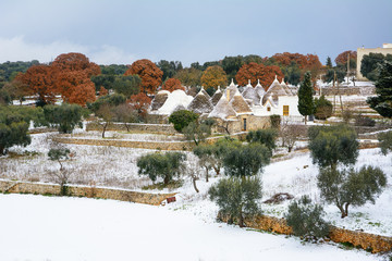Trulli with snow in the Apulian countryside (Italy)