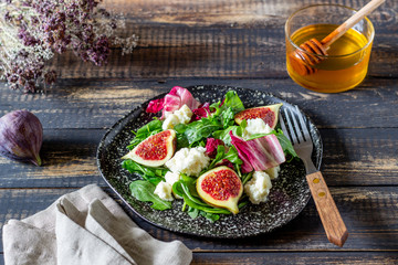 Salad with figs, cheese and honey. Healthy eating.