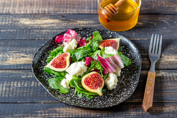 Salad with figs, cheese and honey. Healthy eating.
