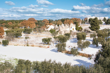 Trulli with snow in the Apulian countryside (Italy)