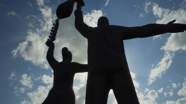 Close-up: Low angle view of stone statues in city against bright sky - Novosibirsk, Russia