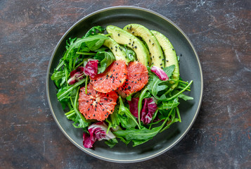 Salad with avocado and grapefruit. Healthy eating. Vegetarian food.