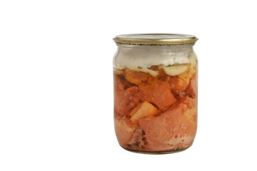 Canned stewed pork meat in a glass jar with slightly rusty metal lid isolated on a white background. Copy space