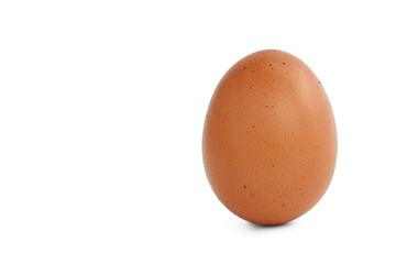 Chicken brown egg isolated on white background. Raw hen egg with speckles and pimples on the shell, standing upright. Сopy space