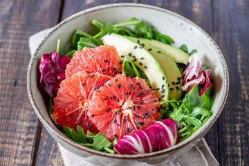 Salad with avocado and grapefruit. Healthy eating. Vegetarian food.