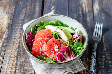 Salad with avocado and grapefruit. Healthy eating. Vegetarian food.