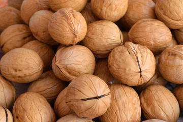 Wet washed walnuts in the shell. Closeup. Food background. Selective focus